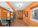 Charming dining area with orange walls, tiled floor, and a built-in shelving unit at 327 Hernando Ave, Sarasota, FL 34243