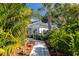 Inviting walkway leads to home entrance, surrounded by lush tropical landscaping at 327 Hernando Ave, Sarasota, FL 34243