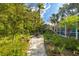 Stone path meanders through a lush tropical garden at 327 Hernando Ave, Sarasota, FL 34243