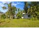 White single-story home with lush green lawn and tropical landscaping at 327 Hernando Ave, Sarasota, FL 34243