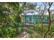 View of a teal pool house from a garden path at 327 Hernando Ave, Sarasota, FL 34243