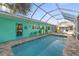 Inviting pool with a screened enclosure and turquoise walls at 327 Hernando Ave, Sarasota, FL 34243