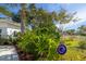 Landscaped yard with tropical plants and a blue glass ornament at 327 Hernando Ave, Sarasota, FL 34243