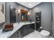 Contemporary powder room with dark cabinetry and marble countertop at 340 S Palm Ave # Pl1, Sarasota, FL 34236