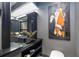 Bathroom with dark vanity and large statement art at 340 S Palm Ave # Pl1, Sarasota, FL 34236