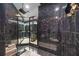 Modern bathroom with black marble and multiple shower heads at 340 S Palm Ave # Pl1, Sarasota, FL 34236