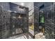 Spa-like bathroom with black marble and rainfall shower head at 340 S Palm Ave # Pl1, Sarasota, FL 34236
