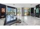 Modern curved kitchen with dark cabinetry, granite counters, and stainless steel appliances at 340 S Palm Ave # Pl1, Sarasota, FL 34236