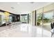 Modern kitchen with marble floors and access to a balcony with water views at 340 S Palm Ave # Pl1, Sarasota, FL 34236