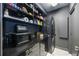 Convenient laundry room with washer, dryer, and shelving for storage at 340 S Palm Ave # Pl1, Sarasota, FL 34236