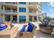 Relaxing patio with blue sofas and wicker furniture at 340 S Palm Ave # Pl1, Sarasota, FL 34236