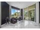 Sitting area with marble floors and large windows overlooking the water at 340 S Palm Ave # Pl1, Sarasota, FL 34236