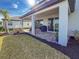 Covered patio with pavers, grill, and lush landscaping at 3704 Wild Blossom Pl, Parrish, FL 34219