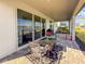 Relaxing covered patio with seating area, overlooking a lake at 3704 Wild Blossom Pl, Parrish, FL 34219
