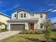 Two story house with a two-car garage and landscaping at 3704 Wild Blossom Pl, Parrish, FL 34219