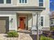 Inviting front entrance with orange door and stone columns at 3704 Wild Blossom Pl, Parrish, FL 34219