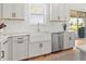 Modern kitchen with farmhouse sink and stainless steel dishwasher at 3704 Wild Blossom Pl, Parrish, FL 34219