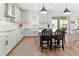 Modern kitchen with white cabinets, island, and hardwood floors at 3704 Wild Blossom Pl, Parrish, FL 34219