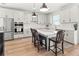 Kitchen island with white cabinets and quartz countertop, seating for three at 3704 Wild Blossom Pl, Parrish, FL 34219