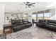 Spacious living room with leather sofas and view of lake at 3704 Wild Blossom Pl, Parrish, FL 34219