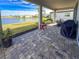 Covered patio overlooking a lake with seating area at 3704 Wild Blossom Pl, Parrish, FL 34219