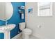 Small bathroom with blue accent wall and pedestal sink at 3704 Wild Blossom Pl, Parrish, FL 34219