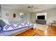 Spacious bedroom with hardwood floors and a TV at 3712 Sandspur Ln, Nokomis, FL 34275