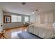 Bright bedroom with hardwood floors, ceiling fan, and ample closet space at 3712 Sandspur Ln, Nokomis, FL 34275