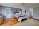 Serene bedroom with hardwood floors, a cozy bed, and access to the bathroom at 3712 Sandspur Ln, Nokomis, FL 34275