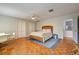 Comfortable bedroom with hardwood floors, ceiling fan, and a sitting area at 3712 Sandspur Ln, Nokomis, FL 34275