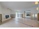 Open living room undergoing renovation with tile flooring and a fireplace at 3712 Sandspur Ln, Nokomis, FL 34275