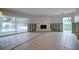 Large living room with fireplace, pool view, and currently undergoing renovation at 3712 Sandspur Ln, Nokomis, FL 34275