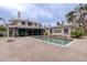 Inviting pool area with brick patio and home view at 3712 Sandspur Ln, Nokomis, FL 34275