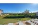Landscaped backyard with lush greenery and patio at 3858 Casey Key, Nokomis, FL 34275