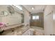 Updated bathroom with granite vanity, large mirror, and walk-in shower at 3858 Casey Key, Nokomis, FL 34275