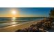 Scenic beach view at sunset with calm waves and rocks at 3858 Casey Key, Nokomis, FL 34275