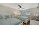 Guest bedroom with two twin beds, ceiling fan, and ample natural light at 3858 Casey Key, Nokomis, FL 34275