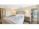 Main bedroom with plush bedding, nightstands, and private access to bathroom at 3858 Casey Key, Nokomis, FL 34275