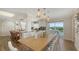 Elegant dining room with a large wooden table and white chairs at 3858 Casey Key, Nokomis, FL 34275