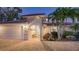 Elegant home entrance with arched walkway and landscaping at 3858 Casey Key, Nokomis, FL 34275