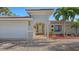 House with white garage door and a brick driveway at 3858 Casey Key, Nokomis, FL 34275