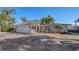 Well-maintained house with a white garage door and palm trees at 3858 Casey Key, Nokomis, FL 34275