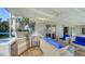 Luxury outdoor kitchen with stainless steel appliances and bar seating at 3858 Casey Key, Nokomis, FL 34275