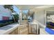 Stainless steel outdoor kitchen with built-in refrigerator at 3858 Casey Key, Nokomis, FL 34275