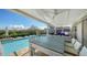 Covered patio with pool and backyard views, dining table, and ceiling fan at 3858 Casey Key, Nokomis, FL 34275