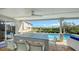 Covered patio with pool views, dining table, and ceiling fan at 3858 Casey Key, Nokomis, FL 34275