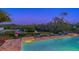 Relaxing pool area with water view at dusk at 3858 Casey Key, Nokomis, FL 34275