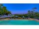 Serene pool overlooking the waterway at night at 3858 Casey Key, Nokomis, FL 34275