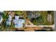 Aerial view of a house and two vacant lots with surrounding trees at 4420 102Nd W St, Bradenton, FL 34210