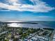 Aerial view showing a waterfront property with surrounding houses and lush greenery at 4420 102Nd W St, Bradenton, FL 34210